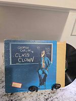 Front jacket and vinyl partially visible on stand