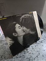 Front jacket of Double Fantasy LP with record partially visible