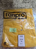 Front of sealed yellow Ranpro reflective coat package showing brand logo and size label.