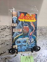 Front cover of The Punisher #76 comic book, bagged and on stand