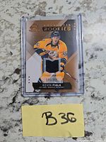 Front view of Kevin Fiala Authentic Rookies jersey card showing player image, jersey swatch and serial number