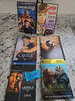 Front view of six DVD cases: Fantastic Four, Anna Karenina, Castle, Black Beauty, Entrapment, Room