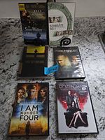 Front covers of all six DVD cases on countertop