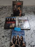 Front view of all four DVD/Blu-ray cases upright on counter