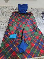 Full view of plaid dress laid flat