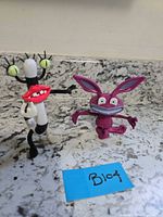 Oblina and Ickis figures standing on countertop with lot tag visible