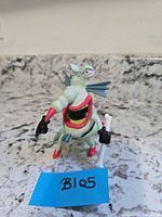 Front view of The Gromble figure standing with cane