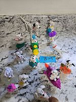 Overview of 13 Dalmatian toys on countertop