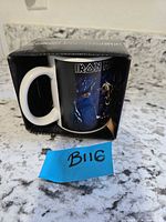 Mug in open retail box, side view showing handle and graphic