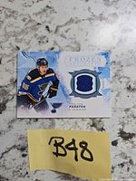 Front of Colton Parayko Frozen Artifacts jersey card showing player image and jersey swatch