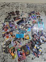 Overview of entire spread of mixed NHL, NBA and WWE cards on countertop