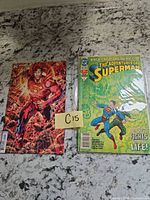 Two bagged Superman comic books side by side on countertop
