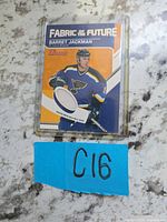 Front view of Barrett Jackman Fabric of the Future jersey card in protective case