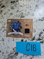 Front of Kari Lehtonen Treasured Swatches jersey card showing player image, fabric swatch and design details