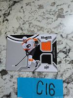 Front of Upper Deck Black Wayne Simmonds jersey card showing two fabric swatches