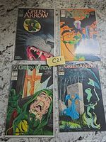 All four Green Arrow comics displayed on countertop