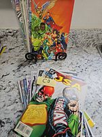 Front view showing stack of comic books with JSA issue on top