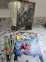 Stack of 15 comic books with The Flash and Green Arrow covers visible