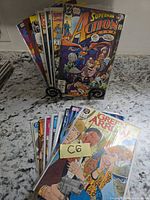 Front view of all 15 bagged DC comic books with Superman in Action Comics and Green Arrow issues visible