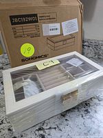 Jewelry box in plastic wrap in front of original Songmics carton showing model JBC192W01
