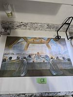 Full view of the unframed Salvador Dali Last Supper print laid on countertop