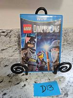 Front view of Wii U LEGO Dimensions game case on stand