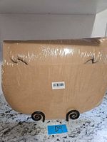 Front view of sealed pack of flat kraft bakery boxes