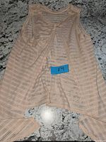 Front view of light peach Lululemon Meet Halfway tank top laid flat