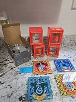 All items together: three UFC Bonus Glass boxes, boxed Yankees Vino tumbler, four Harry Potter coasters