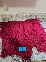 Full view of red rectangular scarf spread out