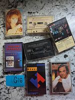 Front view of seven cassette tapes laid out on surface