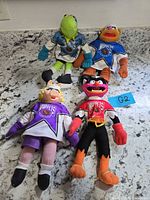 All four Muppet plush dolls on countertop