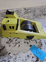 Left side view of yellow Tonka Road Paver toy showing cab, roller, wheels