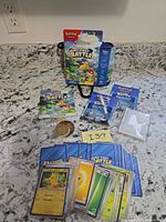 Full set contents laid out including packaging, booklets, cards, coin, counters
