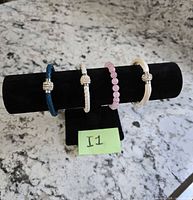 All four bracelets on display stand