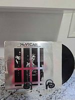 Front sleeve and vinyl record displayed on stand