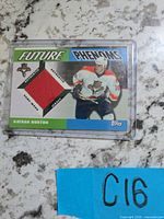 Front of Topps Future Phenoms card showing red jersey swatch and player image