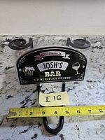 Front of sign showing graphics, suction cups, hook and tape measure for width