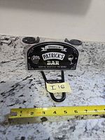 Front view of Patrick's Bar sign showing graphics, suction cups, metal hook and measuring tape for scale
