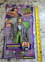 Front view sealed Kevin Matchstick figure with ruler for scale