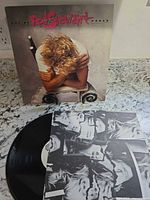 Front album cover and vinyl record with inner sleeve collage side visible