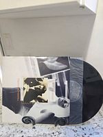 Picture sleeve front and vinyl partially visible