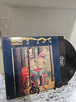 Front cover and vinyl disc partially removed showing Styx label