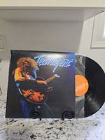 Front cover and vinyl disc displayed, showing Epic orange label and cover art