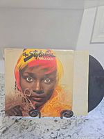 Front cover of The Stylistics Fabulous LP on stand with vinyl partially visible