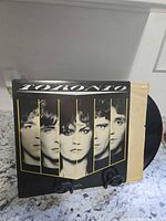 Front jacket view with vinyl partially removed showing cover art and condition