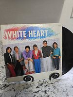 Front jacket showing album title and band photo with record partially visible