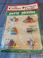 Front of sealed Carrousel party puzzles package showing six multicolor puzzles and header card