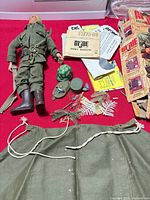 Overview of figure, accessories, manuals and box on red background