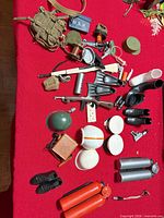 Full layout of all G.I. Joe accessories on red surface
